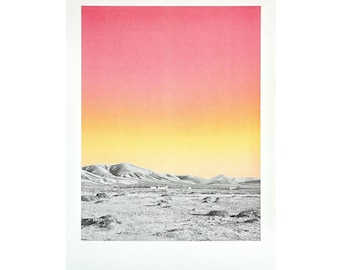 May include: A black and white photograph of a desert landscape with a pink and yellow gradient sky. The mountains in the distance are silhouetted against the sky.