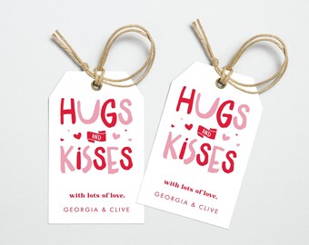 May include: Two white gift tags with red and pink text that reads "Hugs and Kisses" with lots of love, Georgia & Clive. The tags are tied with twine.