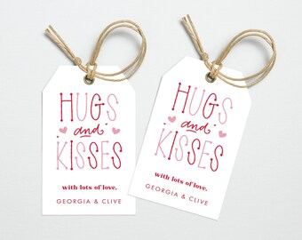 May include: Two white gift tags with red and pink text that reads "Hugs and Kisses" with lots of love, Georgia & Clive.