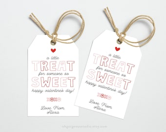 May include: Two white gift tags with red hearts and the text "a little TREAT for someone so SWEET happy valentine's day! XOXO Love From. Alexa" printed on them.