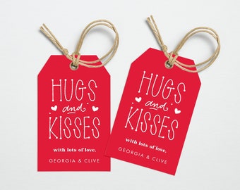 May include: Two red gift tags with white text that reads "Hugs and Kisses" with lots of love, Georgia & Clive.
