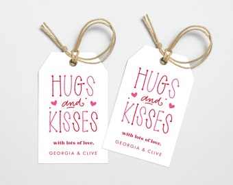 May include: Two white gift tags with red and pink text that reads "Hugs and Kisses" with lots of love, Georgia & Clive.