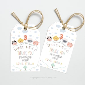 May include: Two colorful thank you tags with a farm animal theme. The tags feature a cow, chick, pig, and sheep with a red balloon that says "3". The text on the tags reads "Three-I-E-I-O Thank You for celebrating with me! Love, Stella".