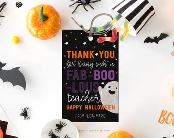 May include: Black and white Halloween teacher appreciation gift tag with purple and orange text that reads "Thank you for being such a Fab-Boo-Lous teacher! Happy Halloween. From Lisa-Marie."