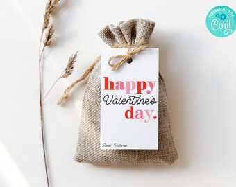 May include: A white gift tag with the text "happy Valentine's day." in red, pink, and black lettering. The tag is tied with twine to a small burlap bag.