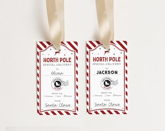 May include: Two red and white striped gift tags with a North Pole Special Delivery theme. The tags have a black and white illustration of a reindeer and a Santa Express stamp. The tags are personalized with the names Olivia and Jackson.