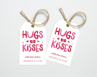 May include: Two white gift tags with red and pink text that reads "Hugs and Kisses" with lots of love, Georgia & Clive.