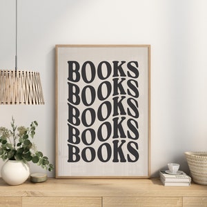 May include: A framed print with the word "BOOKS" repeated five times in a black, stylized font on a white background.
