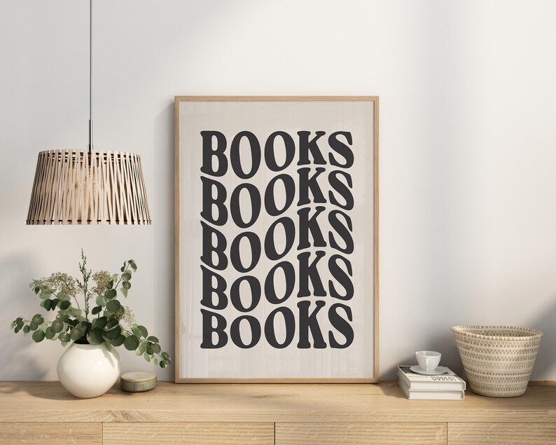 May include: A framed print with the word "BOOKS" repeated five times in a black, stylized font on a white background.