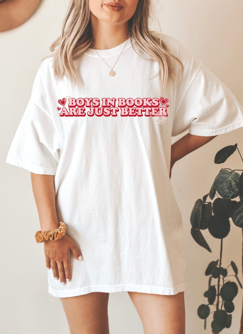 May include: White oversized t-shirt with the text "Boys in Books are just better" in red with hearts around the text.