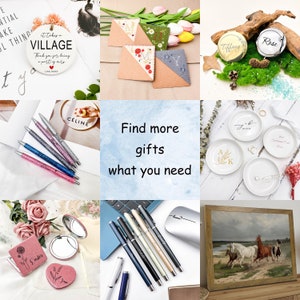 May include: A collage of various personalized gifts, including a round wooden sign with the text "It takes a village", a set of pens with glitter accents, a set of coasters with embroidered letters, a set of ring dishes with floral designs, a set of compact mirrors with engraved names, and a framed painting of horses in a field.