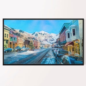 Peut inclure: Une peinture représentant une scène de rue enneigée dans une ville de montagne. La rue est bordée de bâtiments colorés et des voitures sont garées des deux côtés. Les montagnes enneigées se trouvent en arrière-plan.