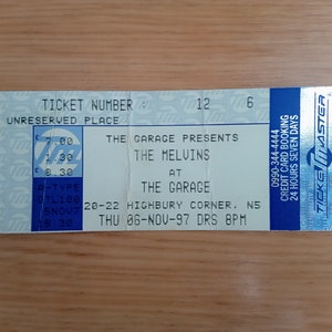 May include: A concert ticket for The Melvins at The Garage, dated November 6, 1997. The ticket is blue and white, with the venue's details and Ticketmaster branding. It includes the ticket number and the time of the show.