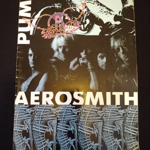 May include: The album cover for Aerosmith's "Pump" features a black and white image of the band. The album title and band name are in white block letters. The Aerosmith logo is in the upper centre.