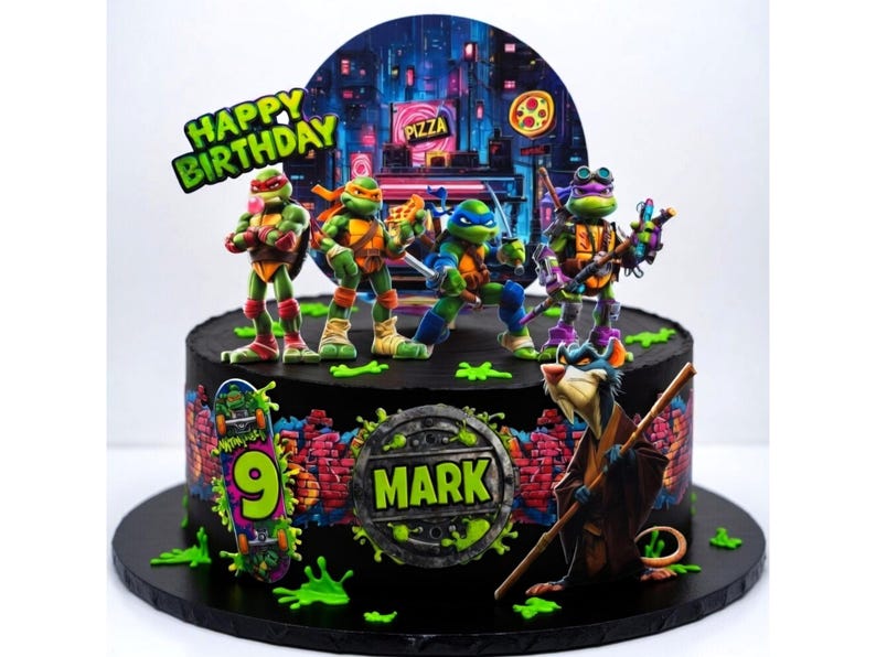 May include: A black birthday cake decorated with Teenage Mutant Ninja Turtles figurines, a cityscape backdrop, and the words "Happy Birthday." The cake also features a skateboard with the number 9 and the name "Mark."