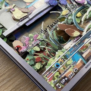 May include: A Pokemon trading card with a blue and white background. The card features a brown and yellow Pokemon with a green, blue, and purple background. The card has the text 'This Pokemon', 'Tackle', 'Weakness', 'Resistance', 'Retreat', 'Illus. MINAMINAMI Toke', 'GSVP 044', 'From the time it is born, a Iron-Mime Jr. would eat its tail. Its life would end.', and '02023 Pokemon/Nintendo/Creatures Inc.'