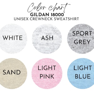 May include: Color chart for Gildan 18000 unisex crewneck sweatshirt in white, ash, sport grey, sand, light pink, and light blue.