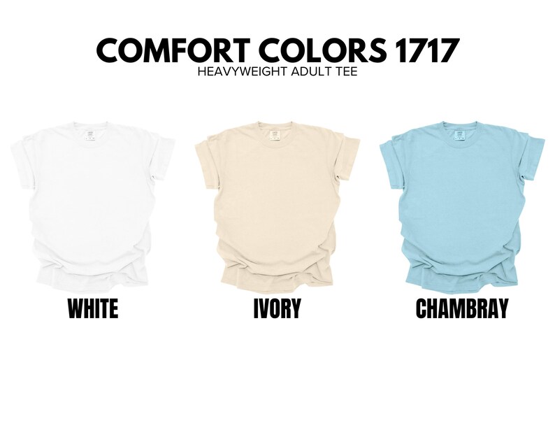 May include: Three t-shirts in different colors: white, ivory, and Chambray. The t-shirts are all the same style, with a crew neck and short sleeves. The text "COMFORT COLORS 1717 HEAVYWEIGHT ADULT TEE" is displayed above the t-shirts.
