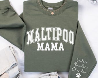 May include: Green sweatshirt with the text "Maltipoo Mama" in white. The sleeve has the names "Sadie, Baxter, Charlee" and a paw print.