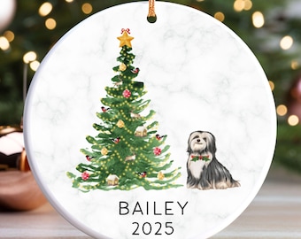 May include: Round Christmas ornament with a marble-like background. A decorated Christmas tree with a gold star sits next to a black and white dog wearing a festive bow. The name "BAILEY" and the year "2025" are printed below.