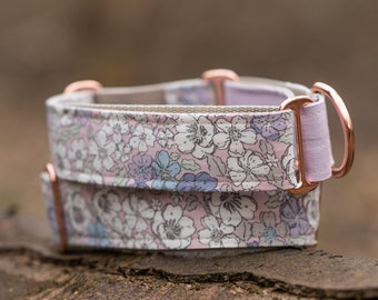 May include: A pink and white floral dog collar with rose gold hardware.