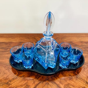 Art Deco blue glass liqueur or shot glass set on a black glass tray