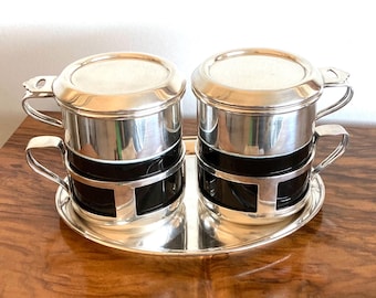 Wiskemann: two silver-plated tip coffee filters on original cups in silver-plated holders, on an oval silver-plated tray