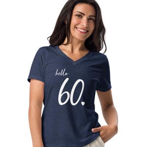 May include: A navy blue v-neck t-shirt with the text "hello 60" in white with a small white heart.