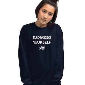 May include: A navy blue sweatshirt featuring the white text "ESPRESSO YOURSELF" and a small coffee cup and saucer graphic. The sweatshirt is a solid colour and appears to be made of a soft material.