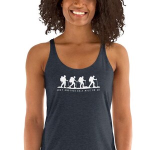 May include: A navy blue racerback tank top with a white graphic of four hikers walking with the text "Just another half mile or so".