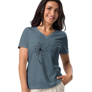 May include: A blue V-neck t-shirt with a black dandelion graphic. The dandelion is blowing in the wind, with some of its seeds floating away.