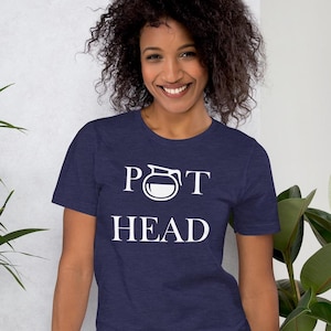 May include: A navy blue t-shirt with white text that reads "POT HEAD" with a coffee pot graphic in place of the "O".