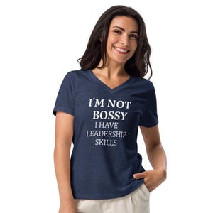 May include: Navy blue V-neck t-shirt with the white text "I'M NOT BOSSY I HAVE LEADERSHIP SKILLS". The shirt is made of a soft material.
