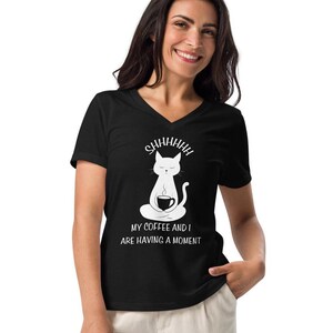 May include: Black v-neck t-shirt with a white illustration of a cat meditating while holding a cup of coffee. The text "SHHHHHHH" is above the cat and the text "MY COFFEE AND I ARE HAVING A MOMENT" is below the cat.