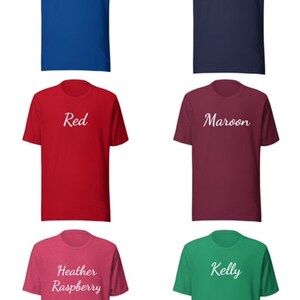 May include: Six t-shirts in different colors with white text. The colors are True Royal, Navy, Red, Maroon, Heather Raspberry, and Kelly.