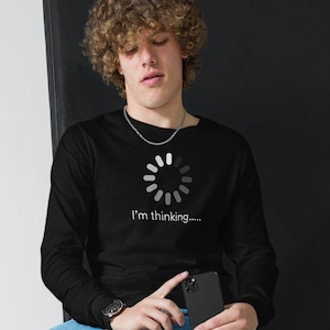 May include: Black long-sleeve shirt with a graphic of a loading circle and the text "I'm thinking...."