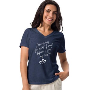 May include: A navy blue v-neck t-shirt with the text "I am sorry for what I said before I had my coffee" in white lettering with two white hearts.