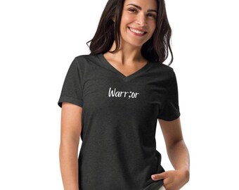 May include: Dark gray V-neck t-shirt with the word "Warrior" in white script. The shirt is made of a soft material and has short sleeves. The text is centered on the chest.
