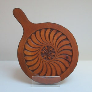 Carved wooden trivet. Traditional trivet, in carved wood, typical of Queyras (French Alps)