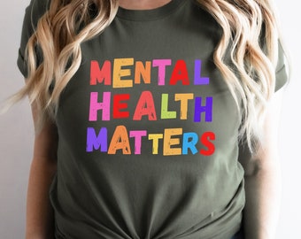 May include: A green t-shirt with the text "MENTAL HEALTH MATTERS" in rainbow colors.