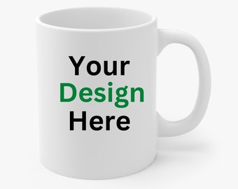 May include: White ceramic mug with the text "Your Design Here" in black and green lettering.