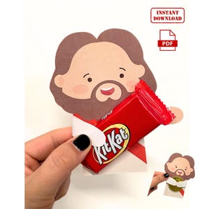 May include: Printable craft template featuring a cartoon character holding a Kit Kat candy bar. The template is designed for a fun and easy craft activity.