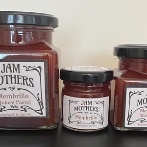 May include: Three glass jars of quince paste, labelled "JAM MOTHERS Membrillo (Quince Paste)" in a vintage-style font. The jars are different sizes, with the largest jar containing 345g of paste, the medium jar containing 160g, and the smallest jar containing 100g. All jars are homemade in the UK.