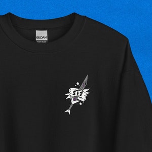 May include: Black sweatshirt with a white graphic of a sword with a banner that says "SIT" on it.
