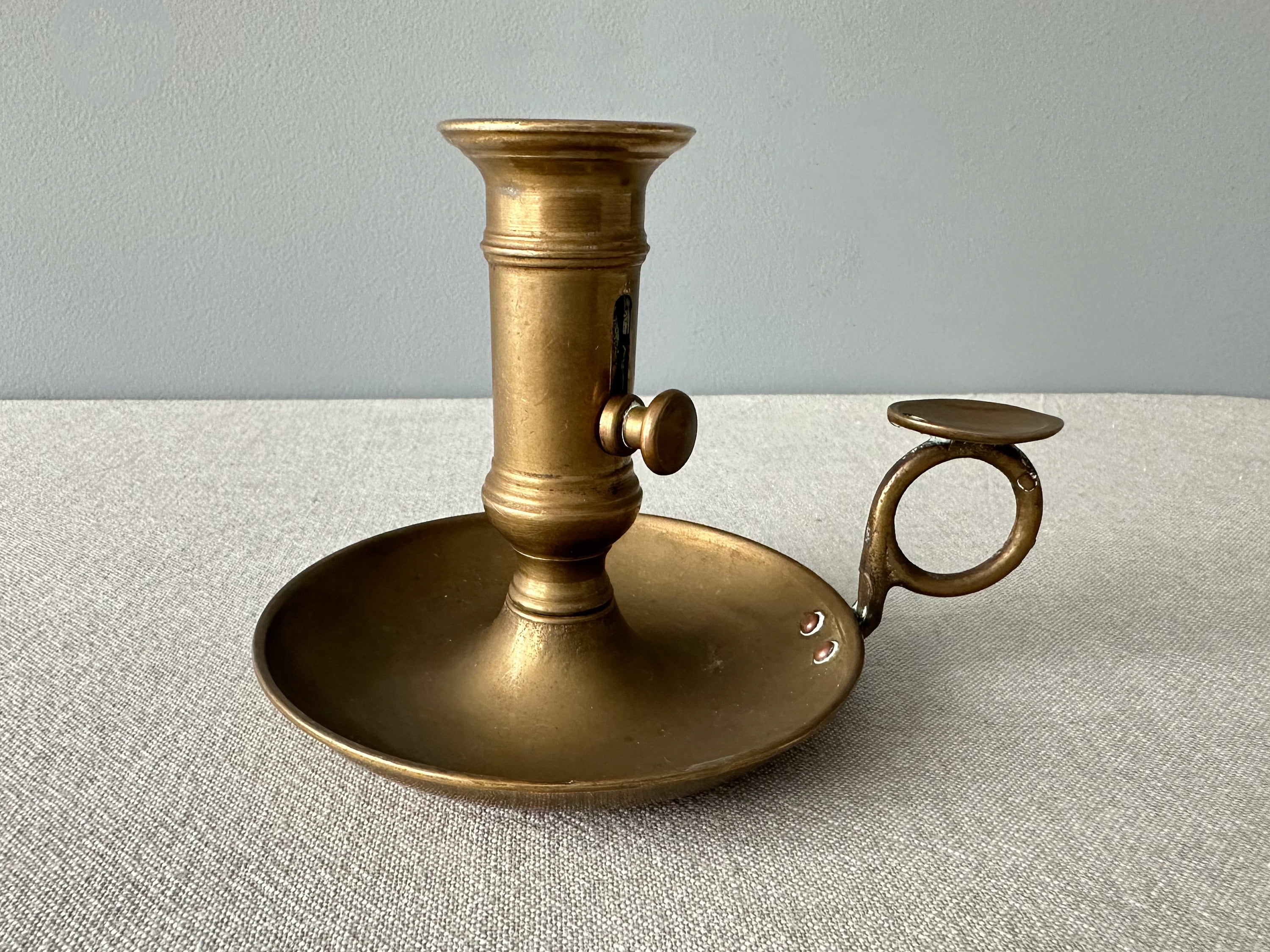 Brass candlestick,with thumb holder, and slide push up, vintage