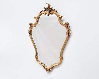 Vintage ingelijste vergulde spiegel met sierlijk decor