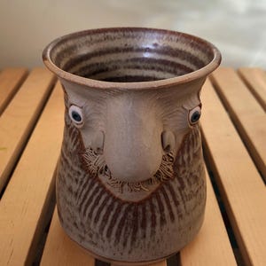 Big Nosed Moustache Face on Brown Glazed Stoneware Mug by Muggins, June 1984