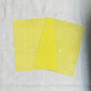 May include: Three yellow plastic canvas sheets, each with a different size, for crafting projects.