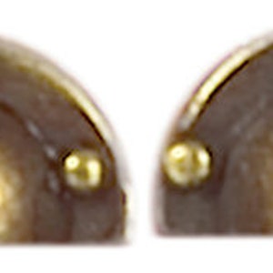 May include: Two half-round, antique brass cabinet pulls with a raised, rounded center and three decorative brass studs.