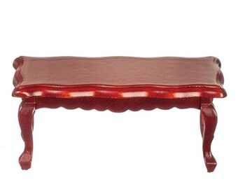 May include: A mahogany coffee table with a scalloped edge and four cabriole legs.
